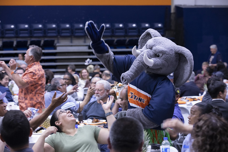 CSUF Mascot Tuffy throws mini stuffed elephants to an adoring crowd.