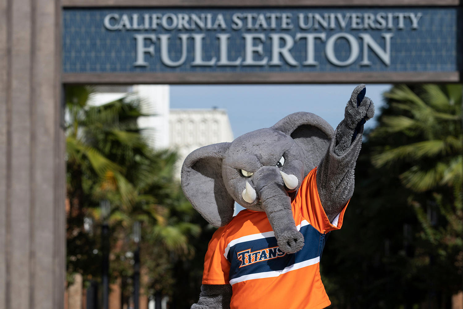 Tuffy in front of the Titan Arch pointing to the sky