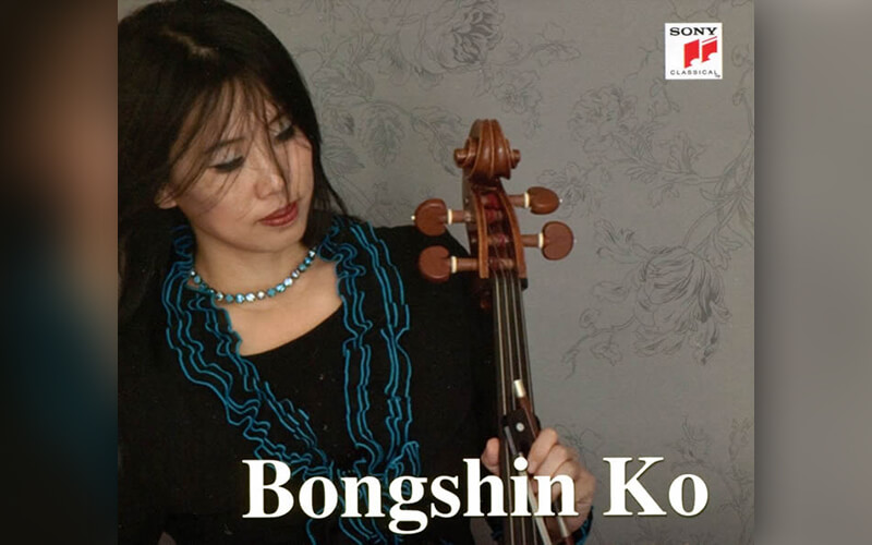Bongshin Ko, professor of music, holding a cello.
