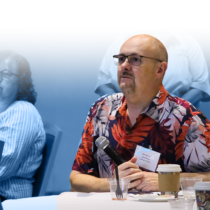 Attentive faculty member holding a microphone