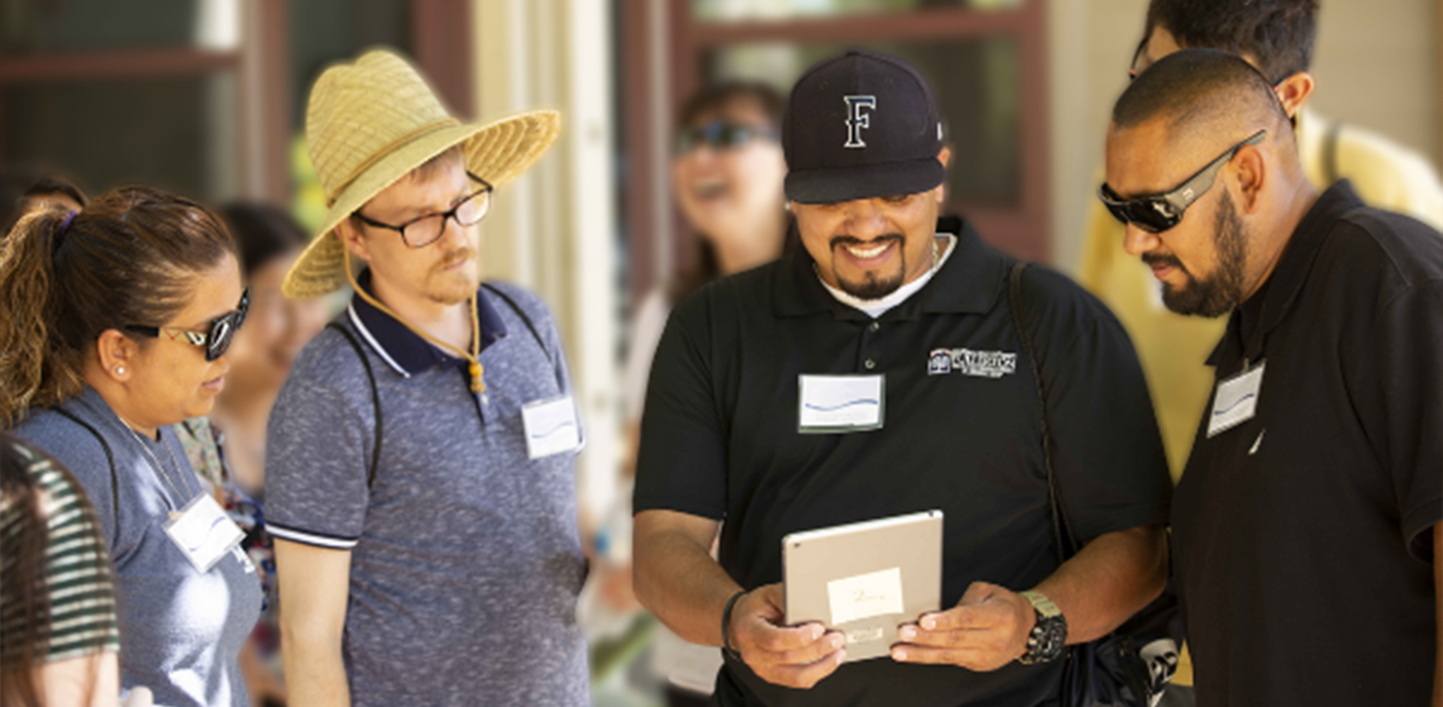 three people sitting together at a table, two of them are shaking hands