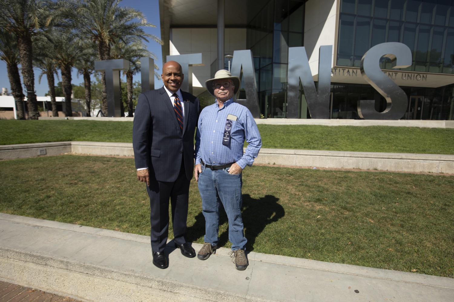 40 Years of Service honoree with President Rochon in front of the Titan Letters