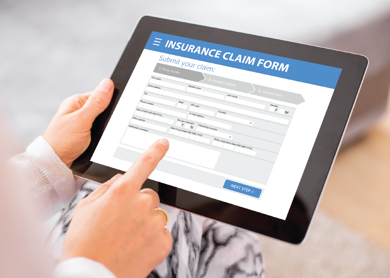 a person filling out an insurance claim form on a tablet