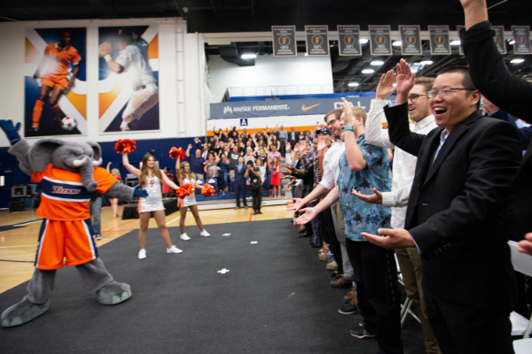a large group of people doing a pose at a CSUF event 